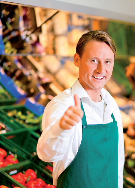 Stores clerk with his thumb up