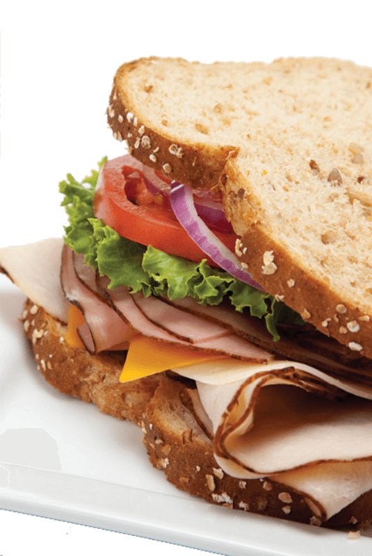 a sandwich with chicken ham cheese lettuce tomato and onion