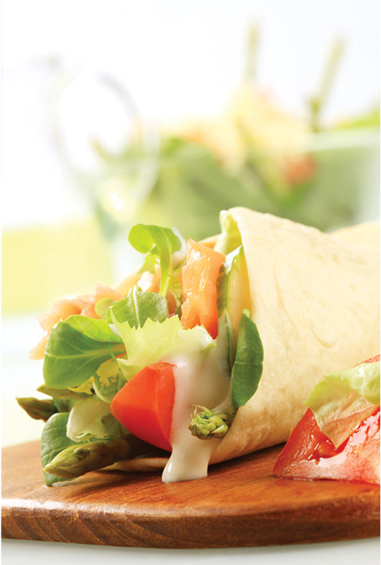 a wrap containing lettuce tomatos and mayonnaise