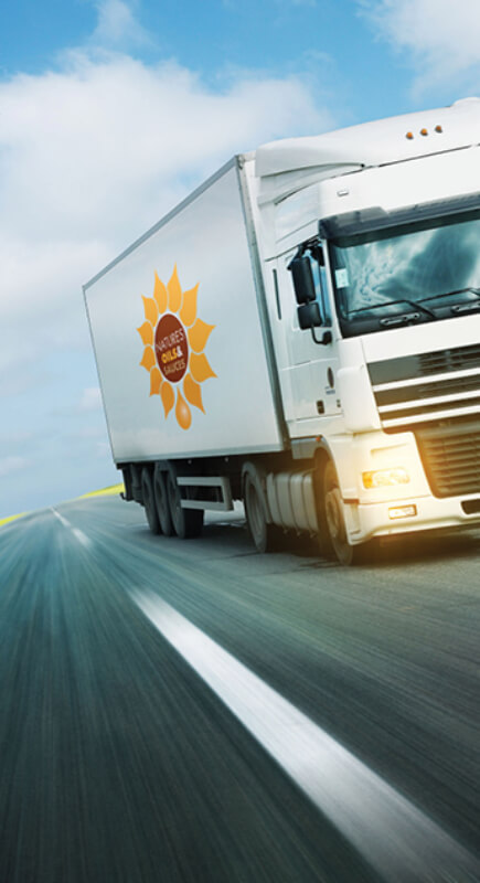a natures oils lorry driving on the road