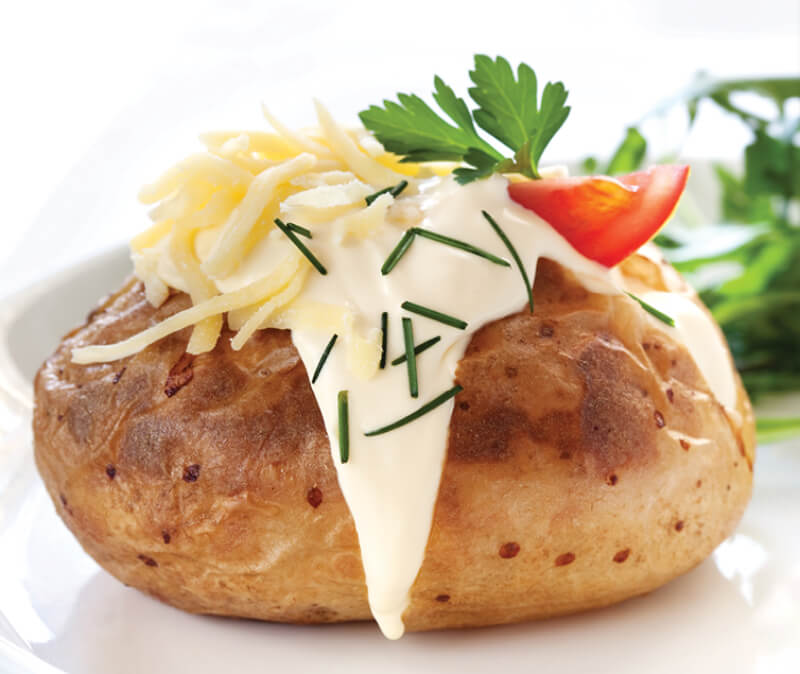 bun with mayonnaise cheese and tomato on top