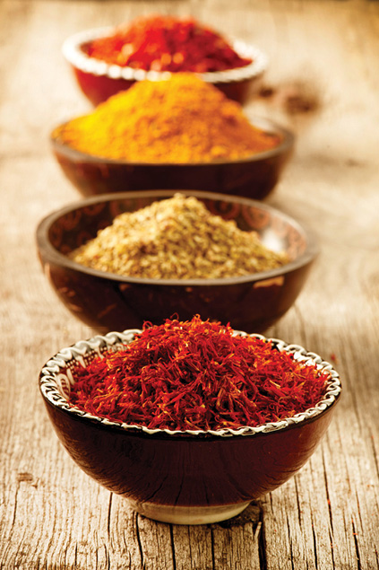 four bowls containing different tikka spices